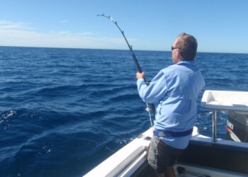 Chris Cleaver with his recently caught and released hybrid cod he likes to call a Murrout (cross between a Murray and trout cod).